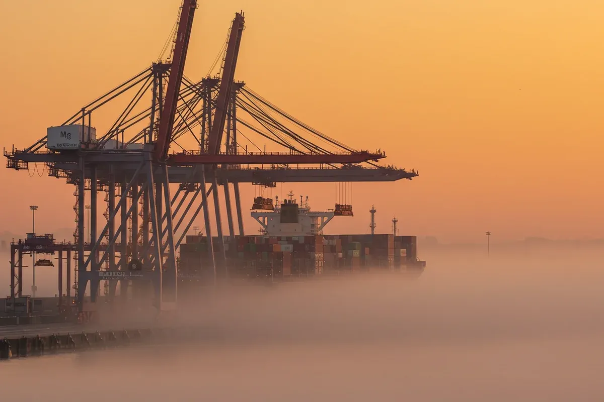 Tower cranes dominate the Port Administration of Maryland with ships shrouded in a dense coastal fog creating a hazy