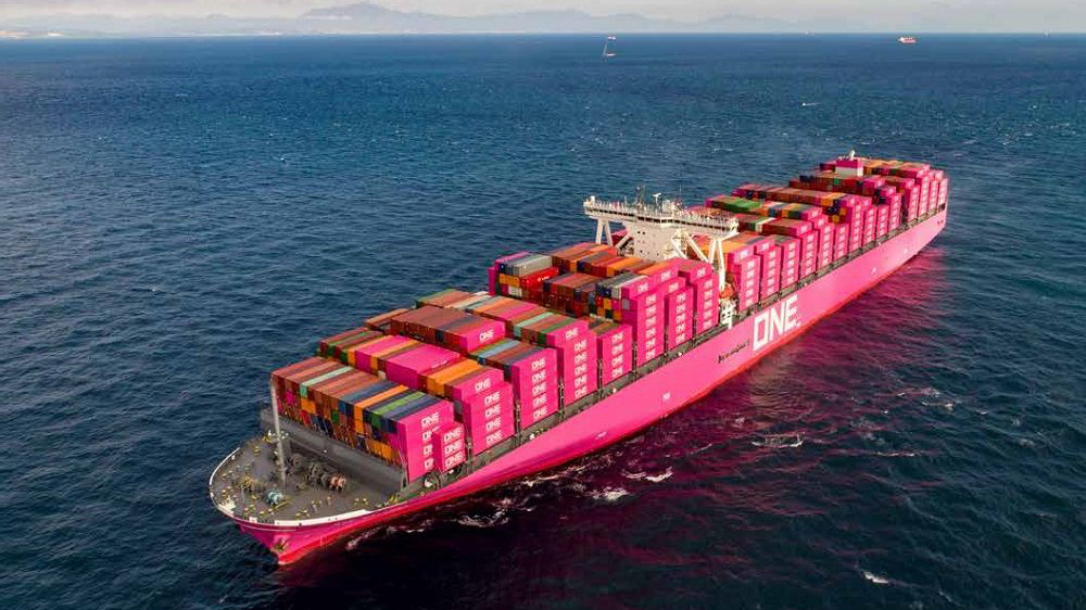 A vibrant pink container ship ONEY navigates the open ocean its hull dominating the frame a symbol of global shipping
