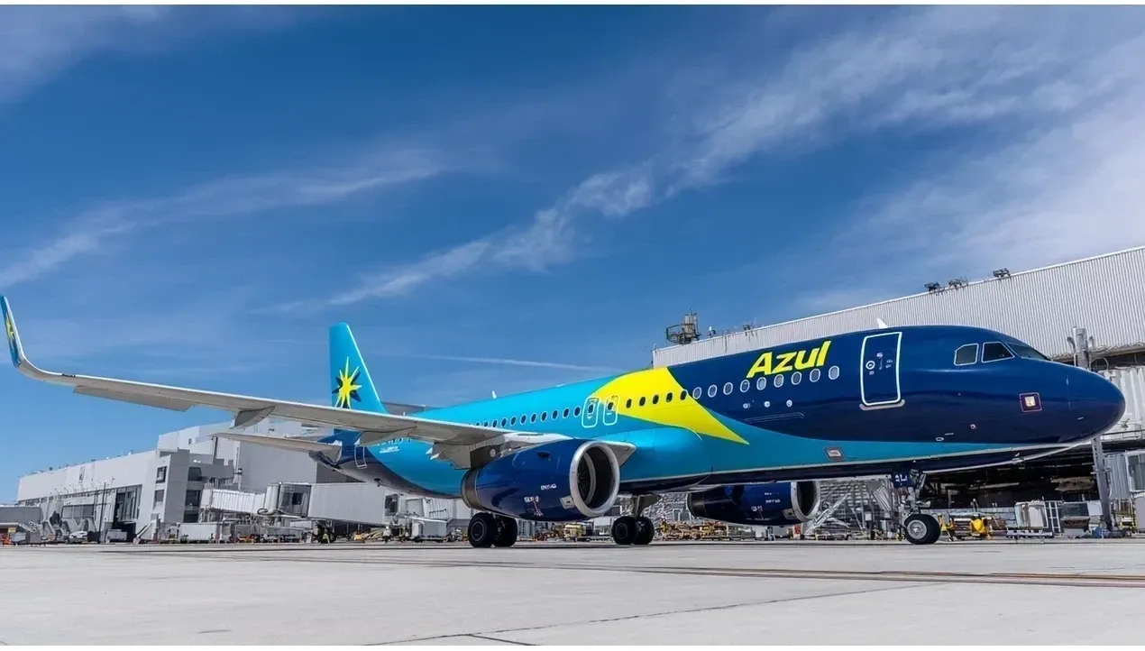 An Azul Brazilian airline aircraft stands at an airport terminal with bright blue and white livery It appears to be a hero