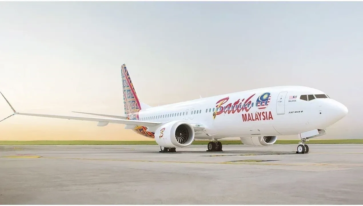 A Batik Air Airbus A320 aircraft stands on the tarmac with vibrant batik designs painted on its fuselage a prominent detail