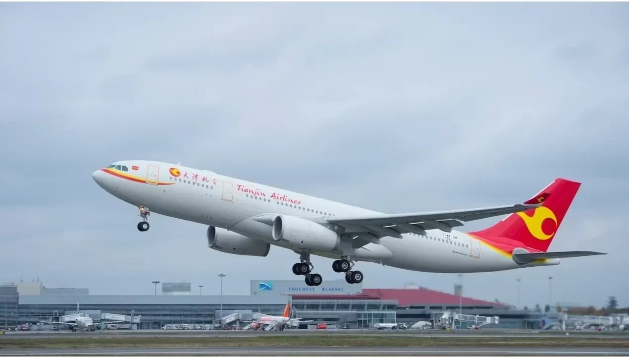 A large red Chinese Airlines passenger jet ascends rapidly from a runway during takeoff creating a strong sense of movement