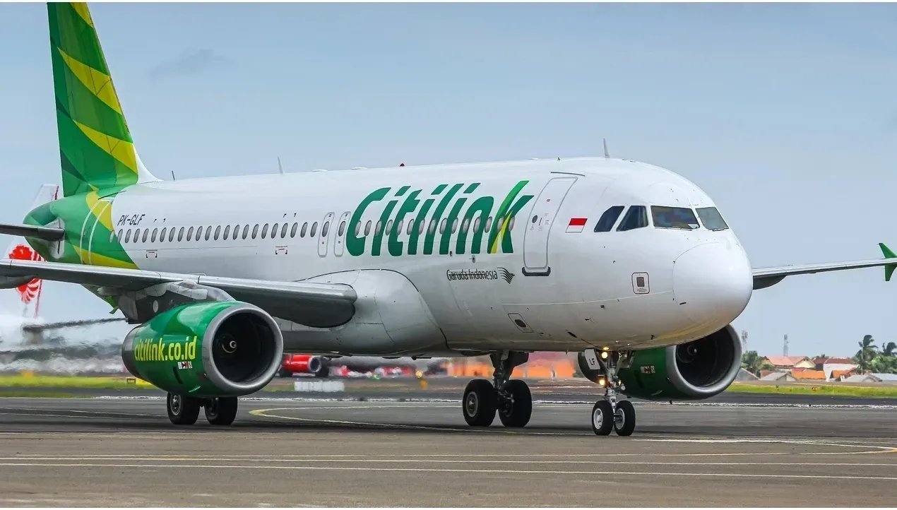 A Citilink aircraft rolls along the runway with blurred motion emphasizing speed and movement of the plane