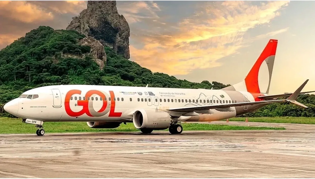 A Gol Airlines Boeing 737 aircraft sits on the ground with its distinctive red and white livery prominent in the Brazilian