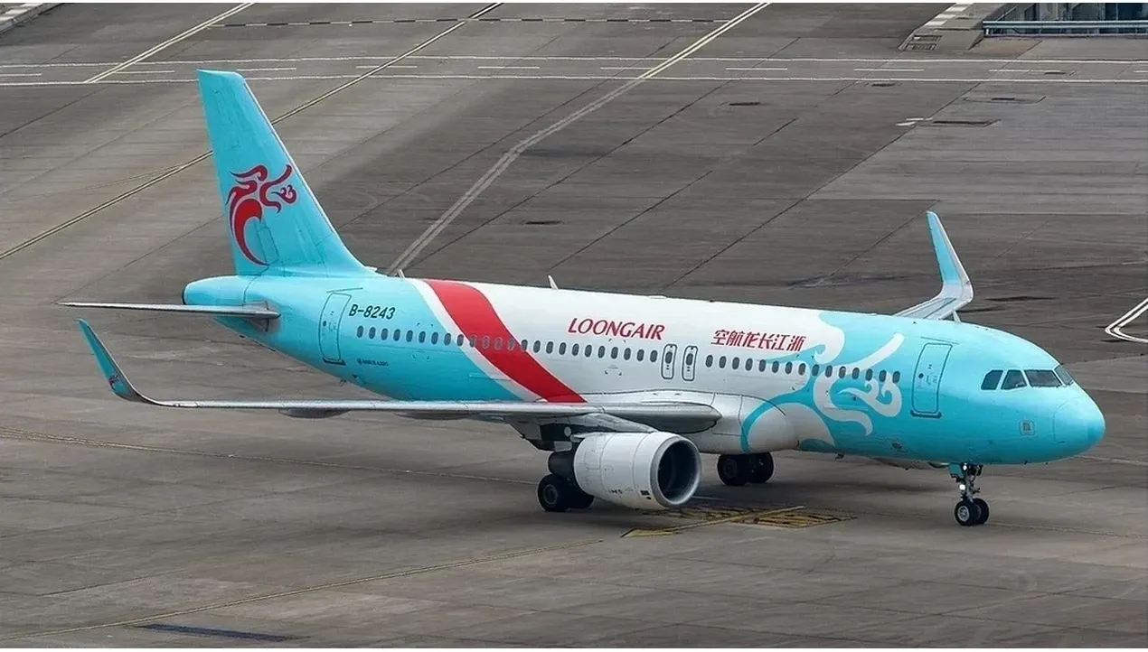A blue loong air airplane flies across the sky in motion highlighting its sleek design and vibrant color scheme