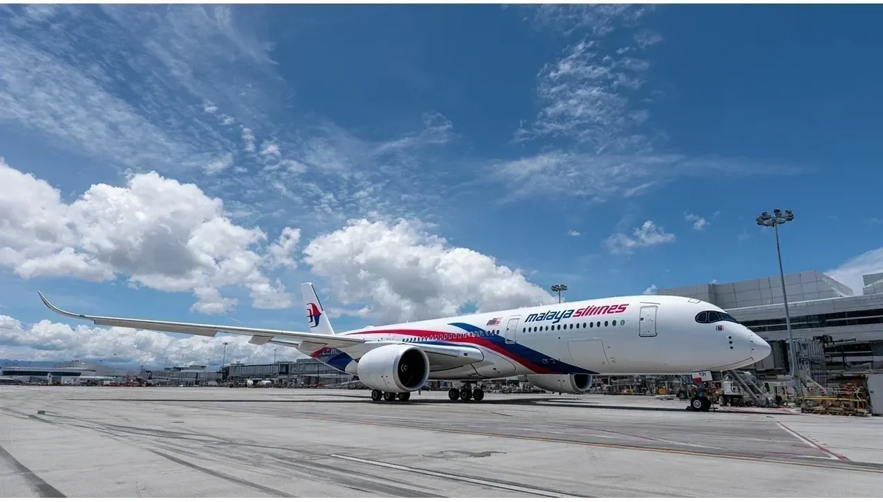 A Malaysia Airlines Boeing 737800 aircraft sits on the tarmac at an airport terminal ready for departure