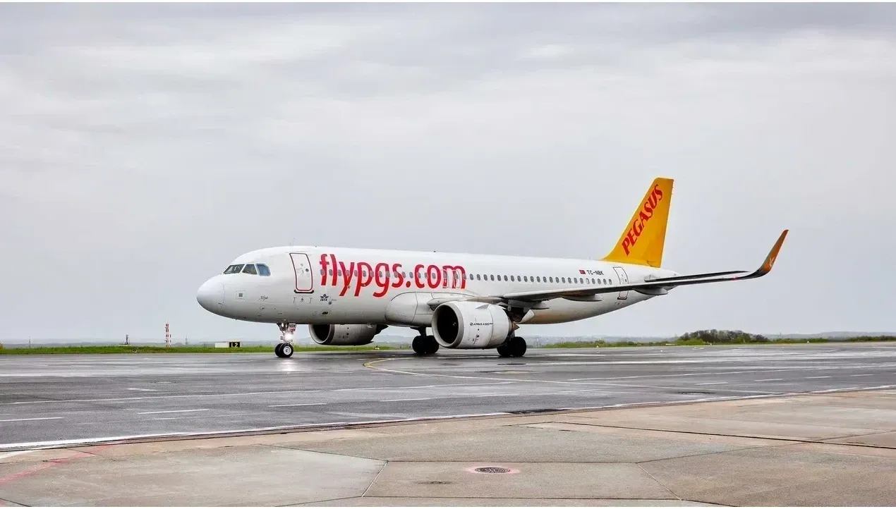 A Pegasus Airlines Boeing 737800 aircraft is pictured on a runway ready for takeoff with its distinctive orange livery