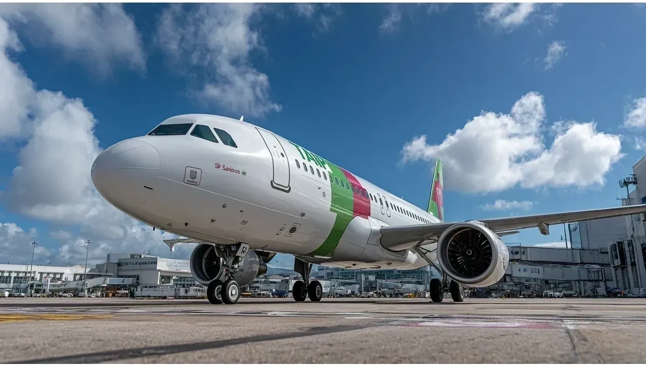 A bright green TAP Air Portugal aircraft stands on the tarmac with two engines visible ready for takeoff a modern symbol of