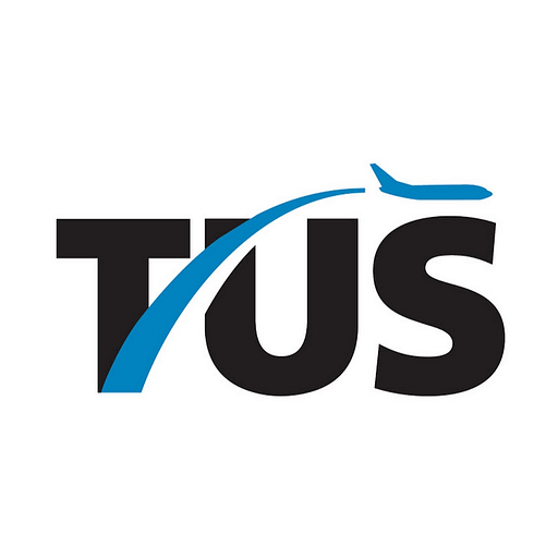 Tucson International Airport logo features a stylized airplane within a blue circle representing the airports branding