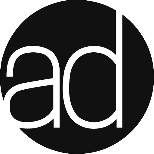 A minimalist logo featuring a stylized letter A with a subtle decorative element resembling a flourish or accent design