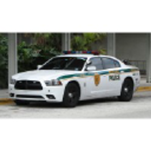 A white police car with a blue light on top stands prominently on a yellow road surface The cars details are visible