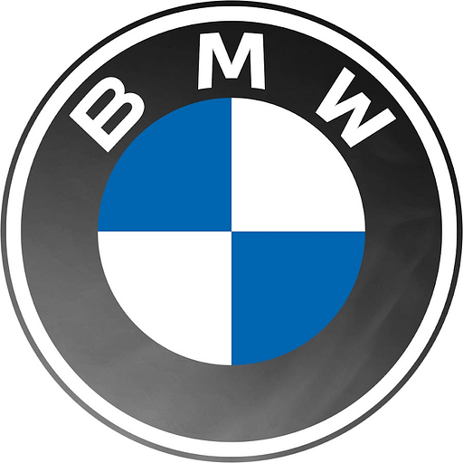 A white and blue BMW logo displays against a blurred gray background The iconic emblem represents the automotive brands