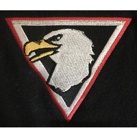 A white eagle head with a black background and red border The eagles head is facing forward with its beak open and detailed