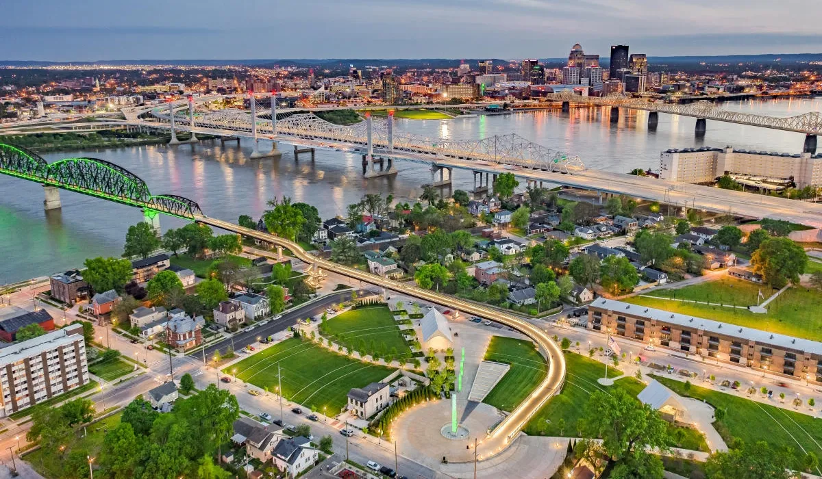 A highangle view showcases Jeffersonville Indiana with a curved roadway and a prominent central fountain amid residential